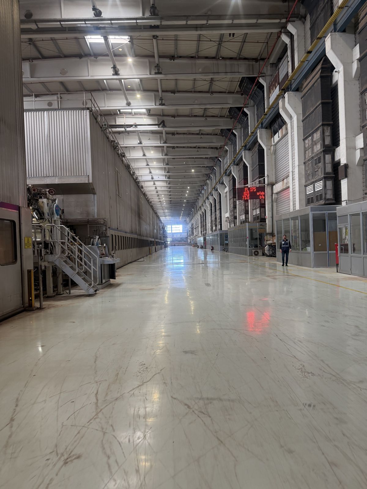 Paper machine hall with a long polished floor beside the machine